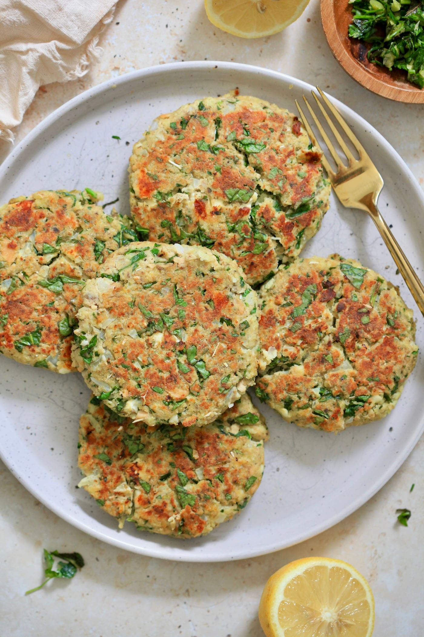 overhead view salmon burgers on plate with lemon