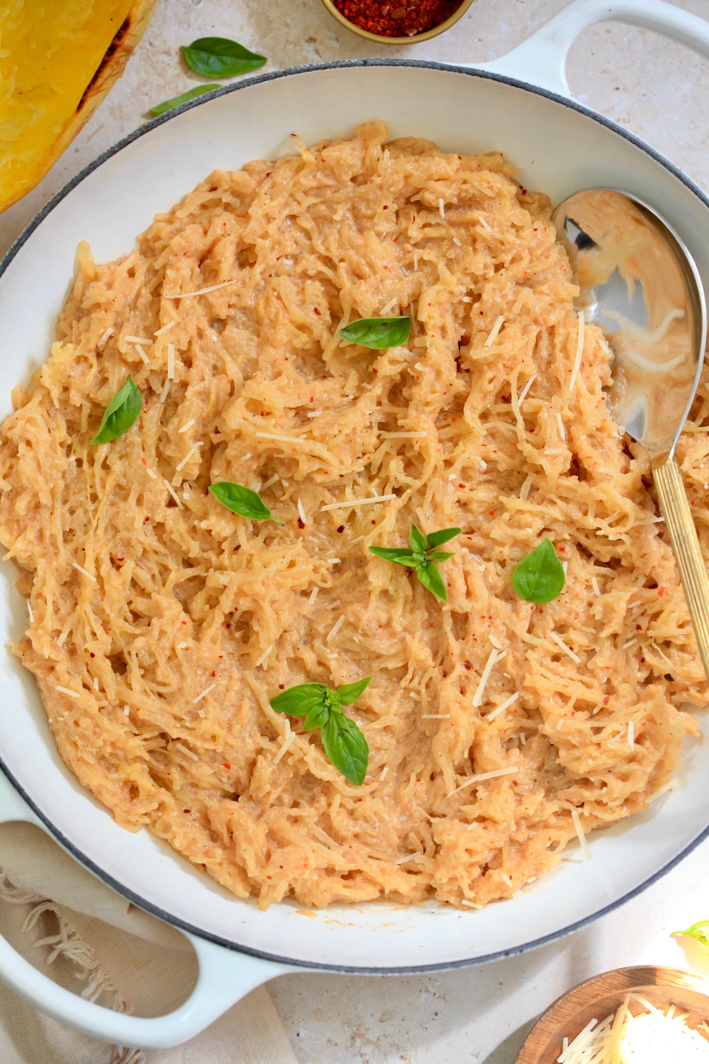 white skillet with creamy tomato spaghetti squash.