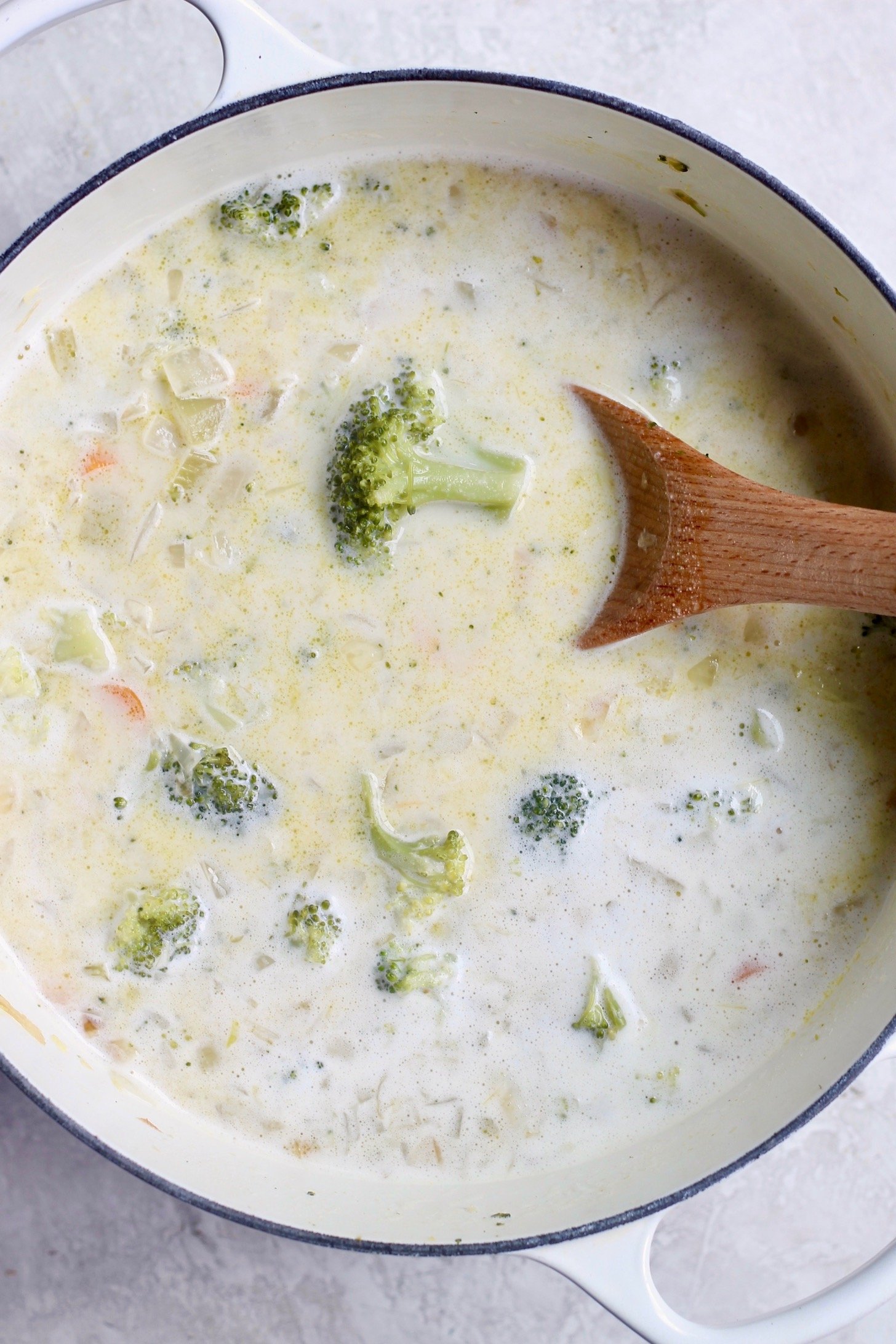 soup pot with white liquid and broccoli