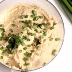 food processor with cauliflower and green onions