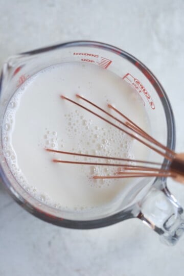 whisking liquid in measuring cup