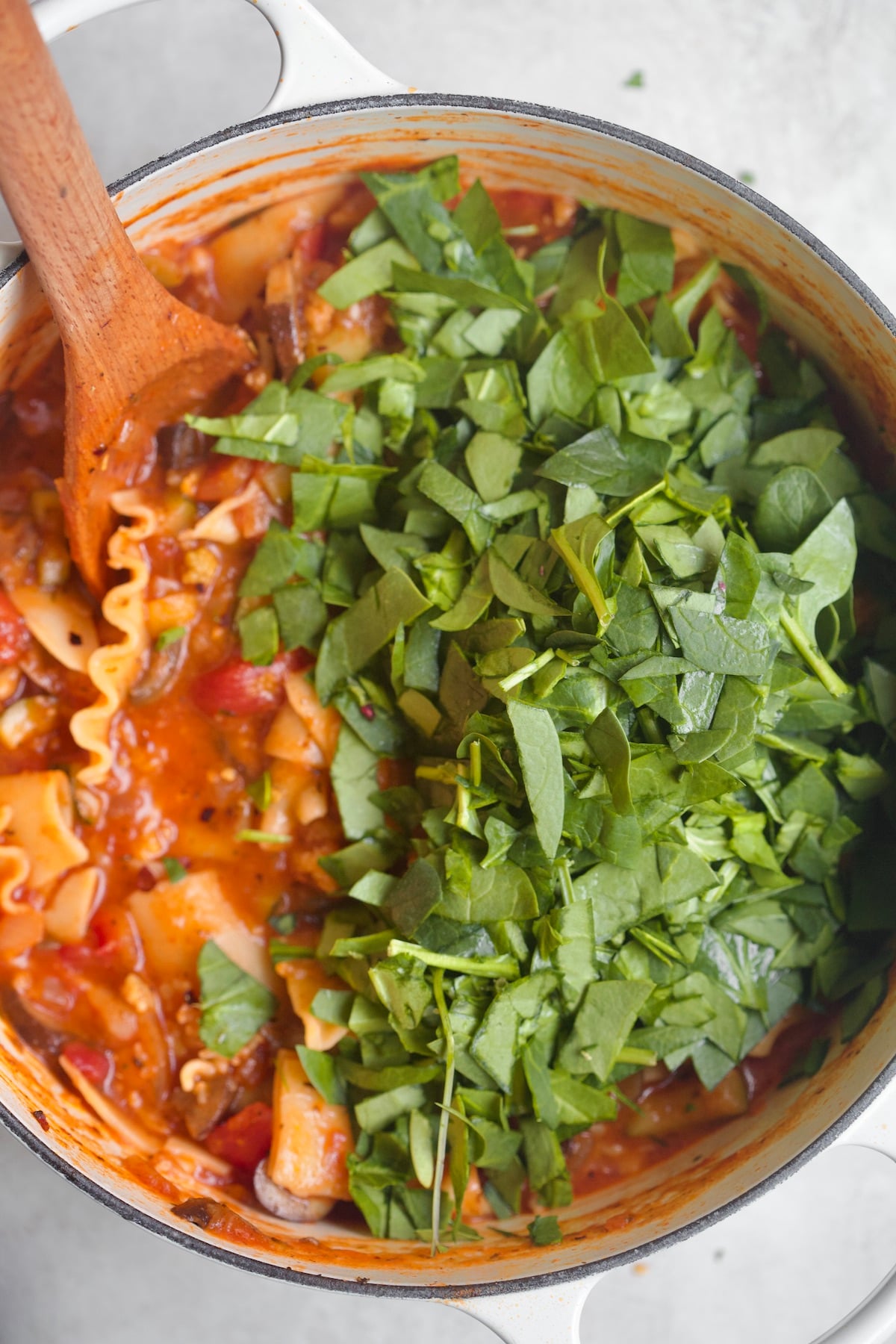 pot of red soup with spinach