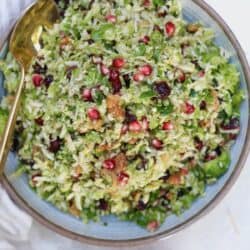bowl of colorful salad with gold spoon