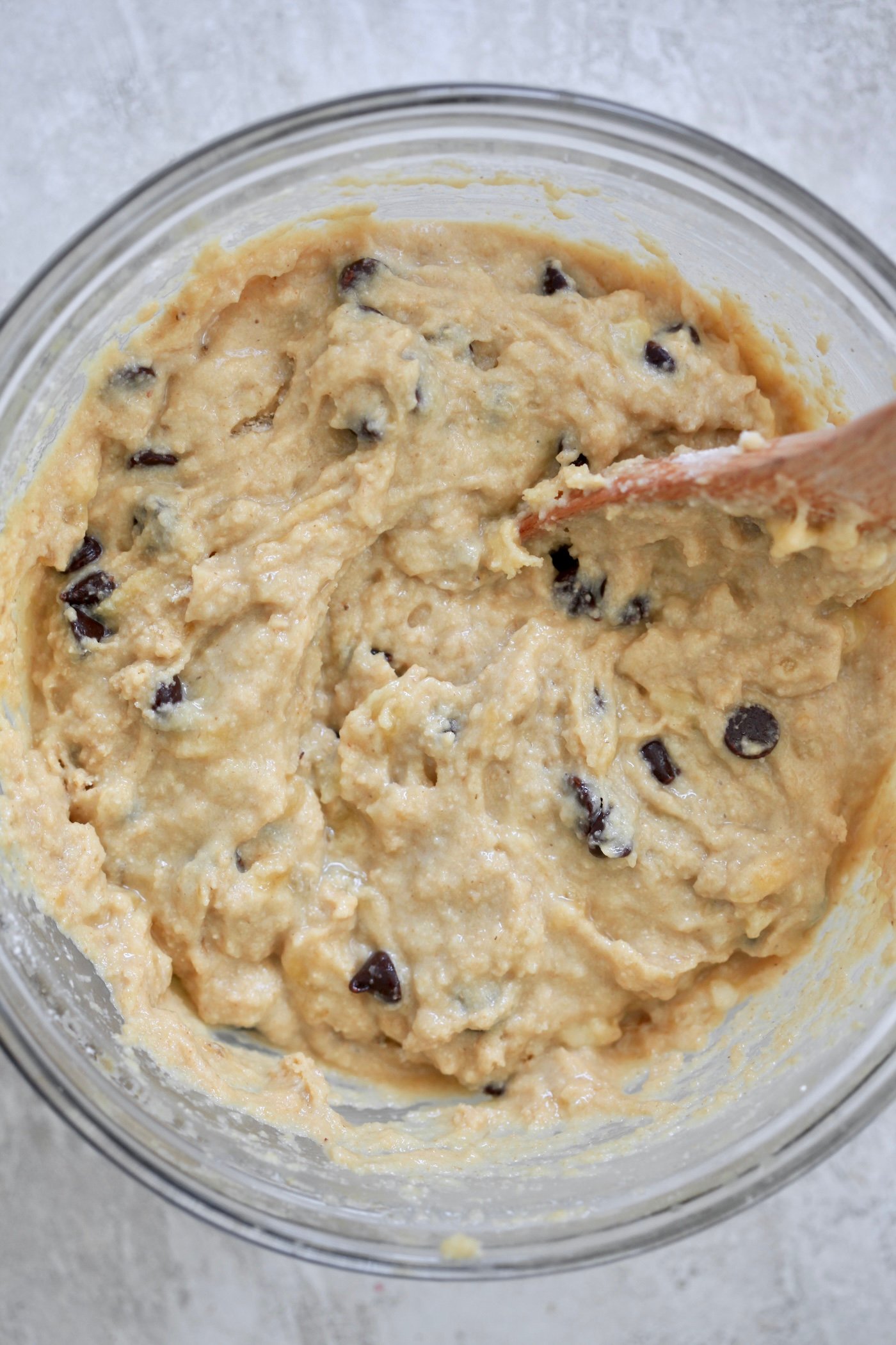 mixed yellow batter with wooden spoon.