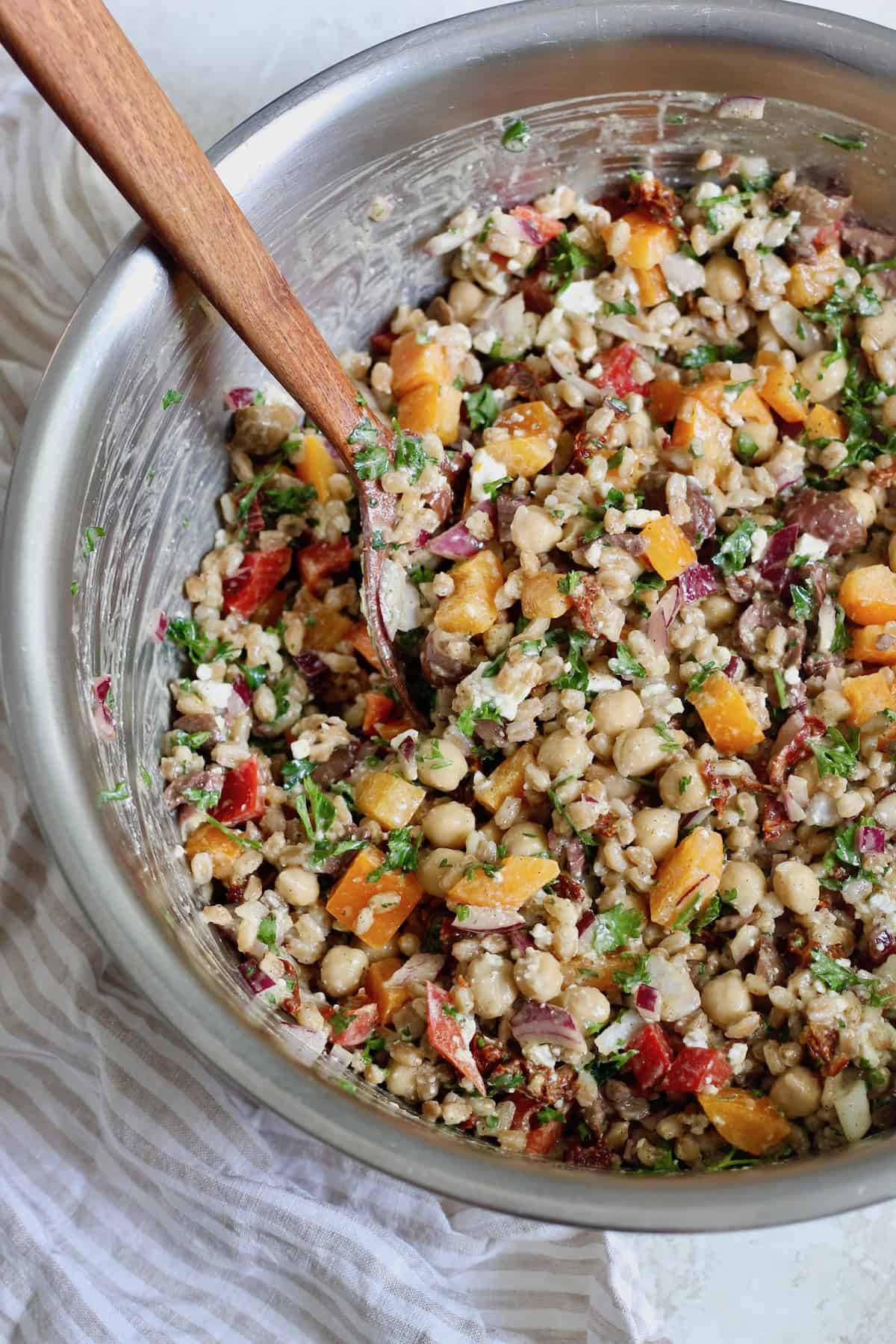 bowl with wood spoon and salad