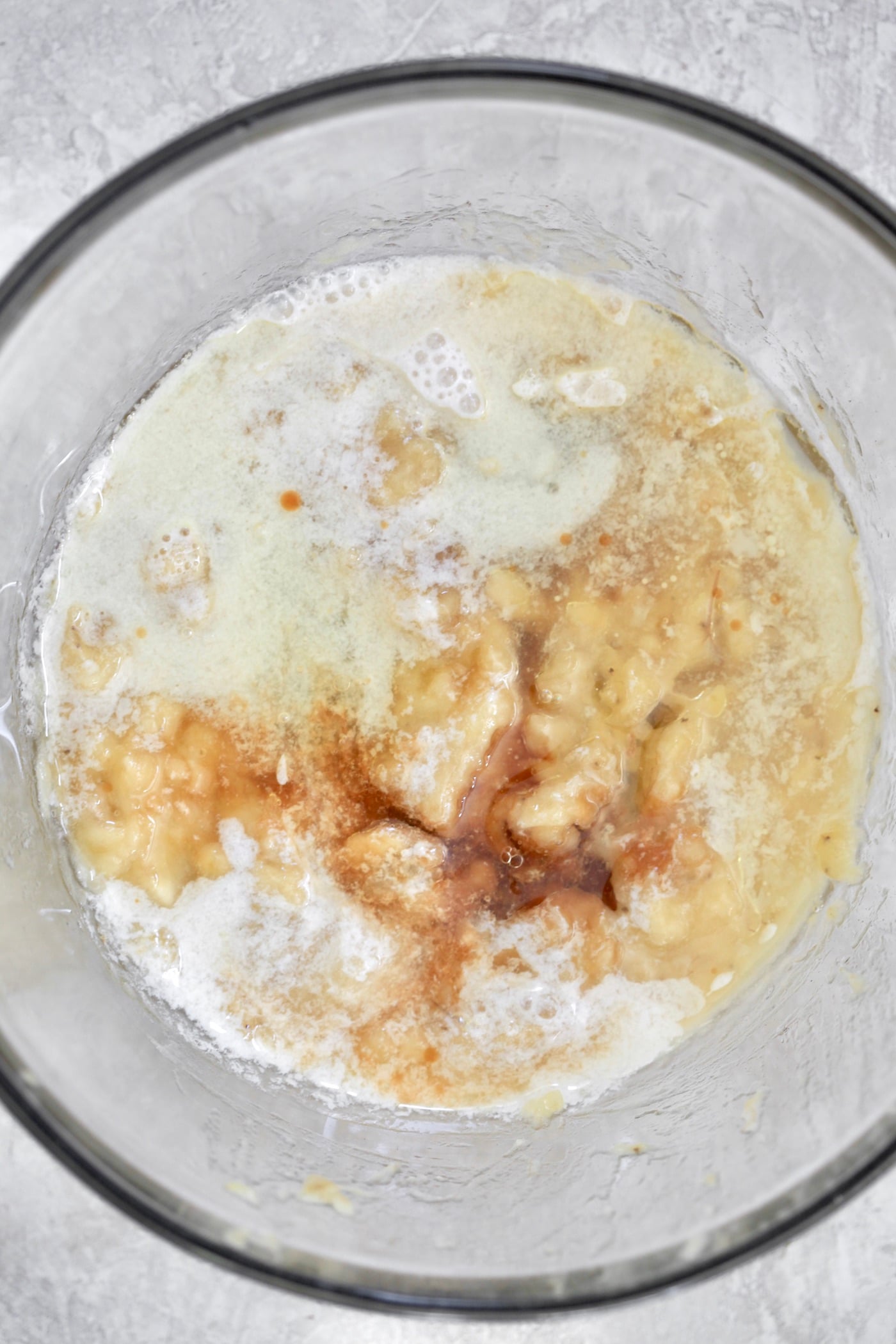 mixing bowl with banana, oil, milk