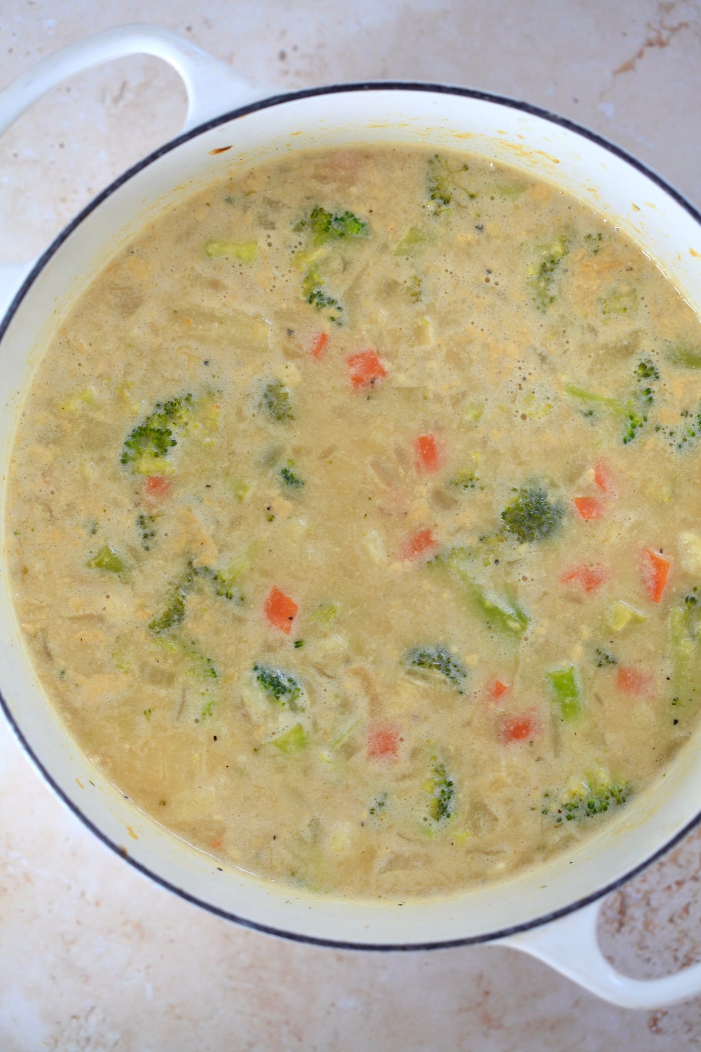 pot of yellow soup with veggies.