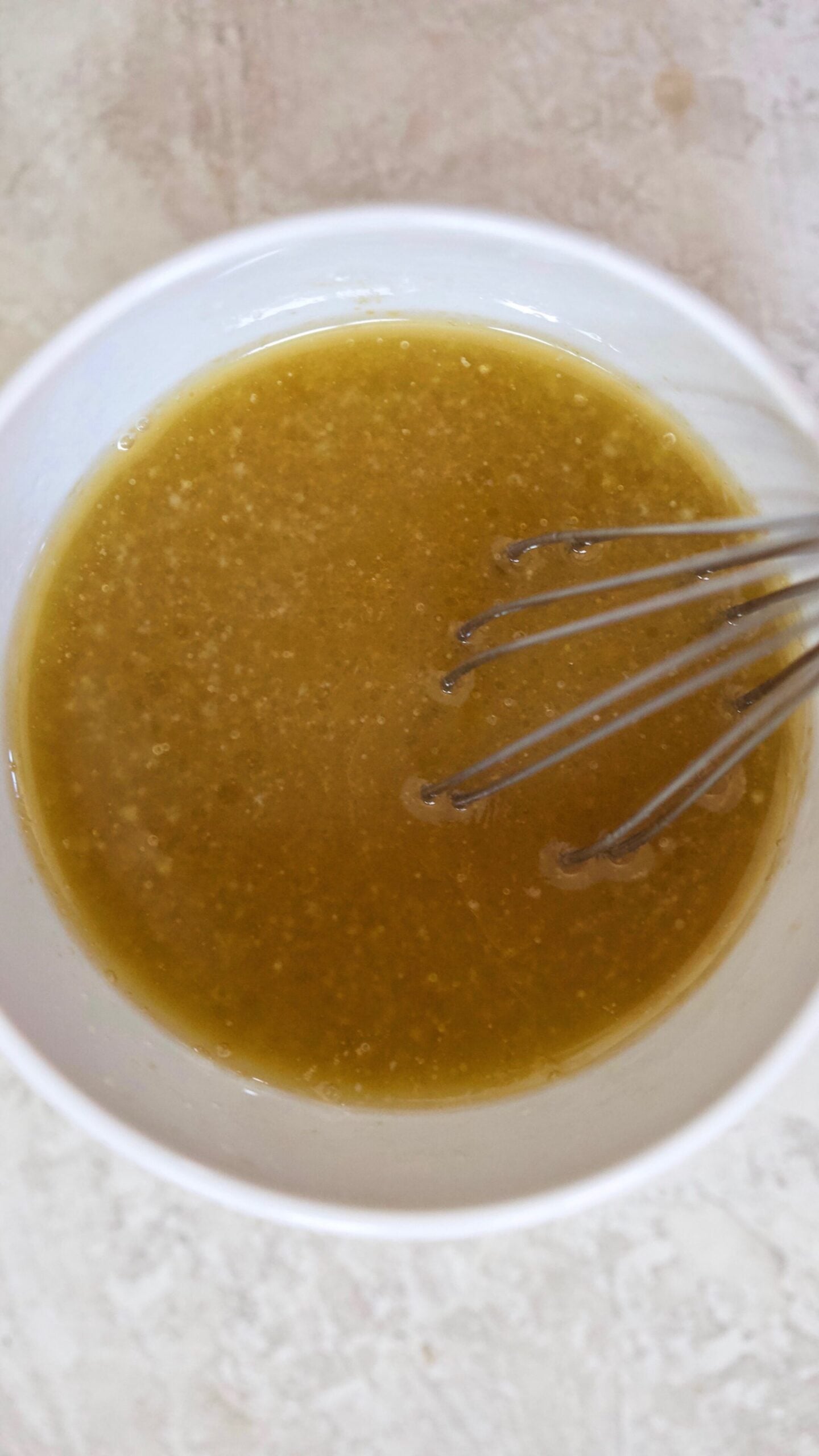 whisking dressing in bowl.