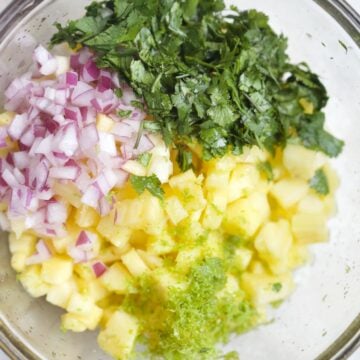 pineapple salsa ingredients in bowl.