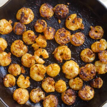 shrimp cooking in cast iron skillet.