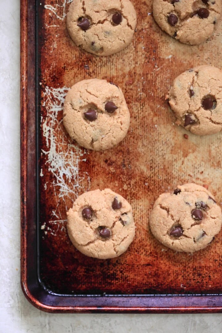 baked chocolate chip cookies on sheet pan.