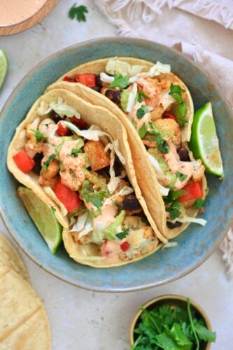 blue bowl with veggie stuffed tacos in it.