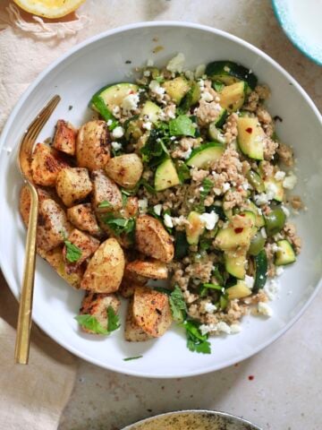 bowl of chicken and zucchini with potatoes.