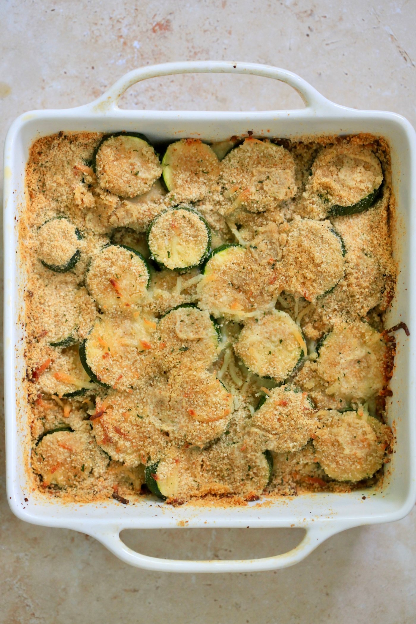 cooked zucchini casserole in baking dish.