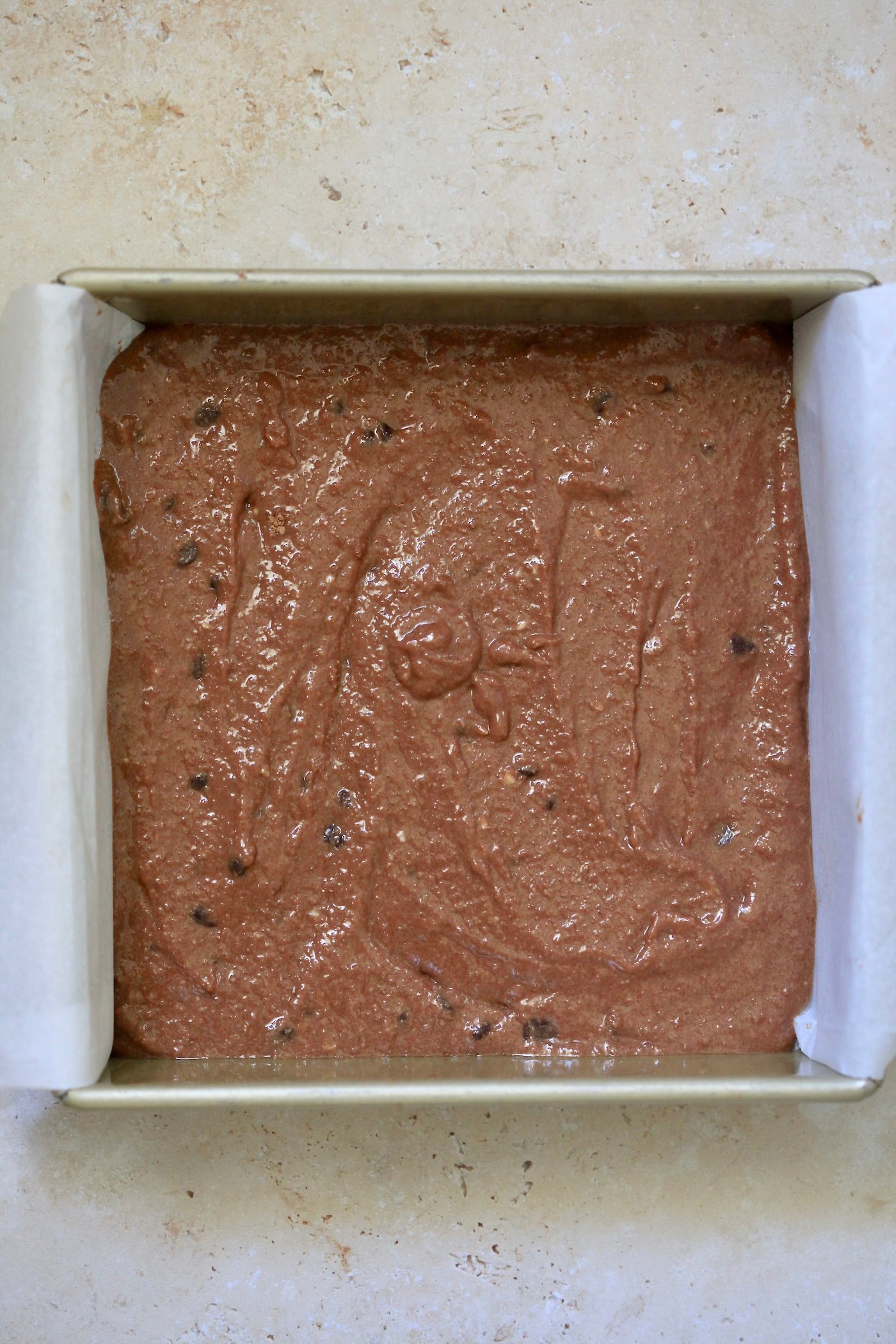 uncooked brownie batter in pan