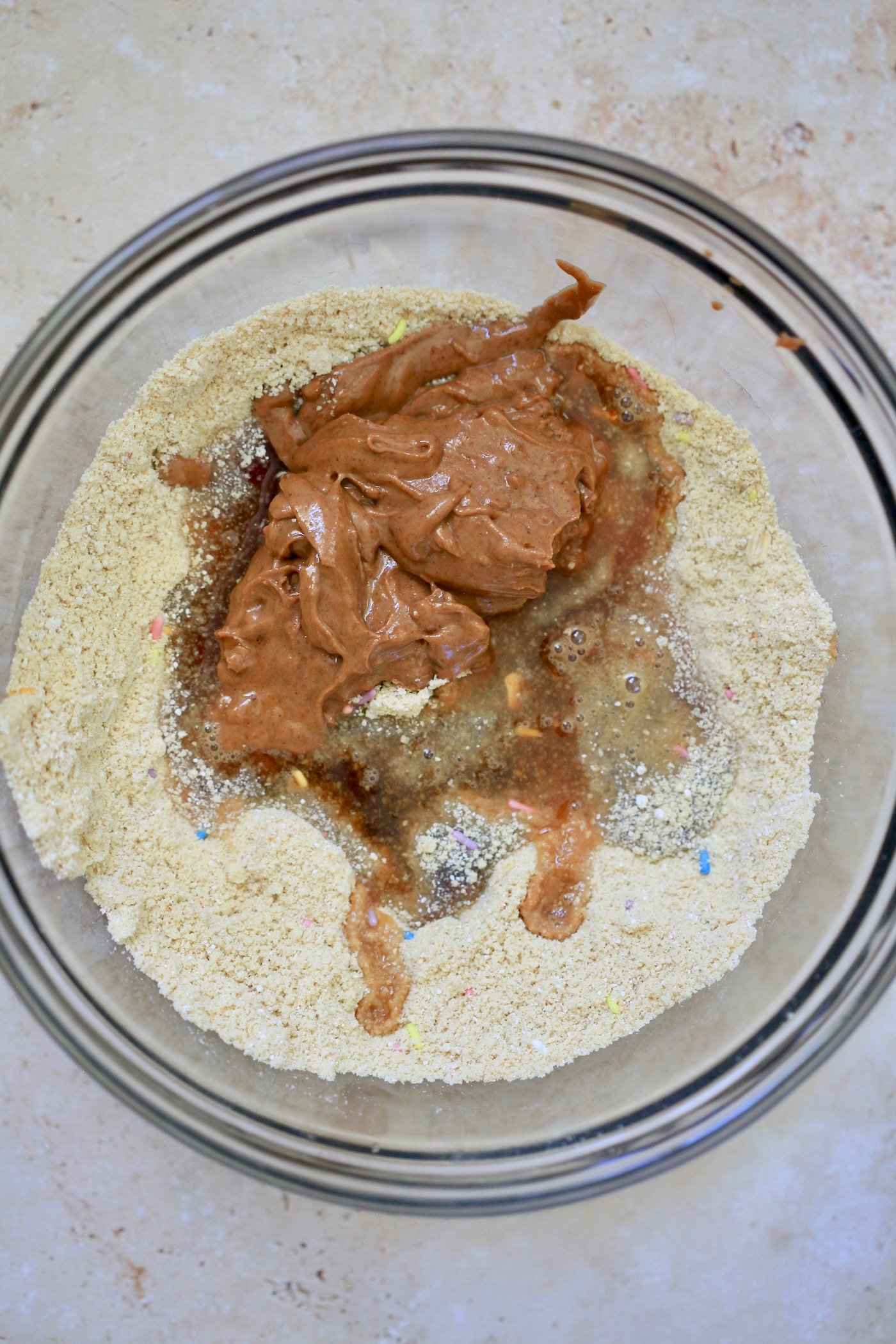 almond butter in bowl with dry ingredients.