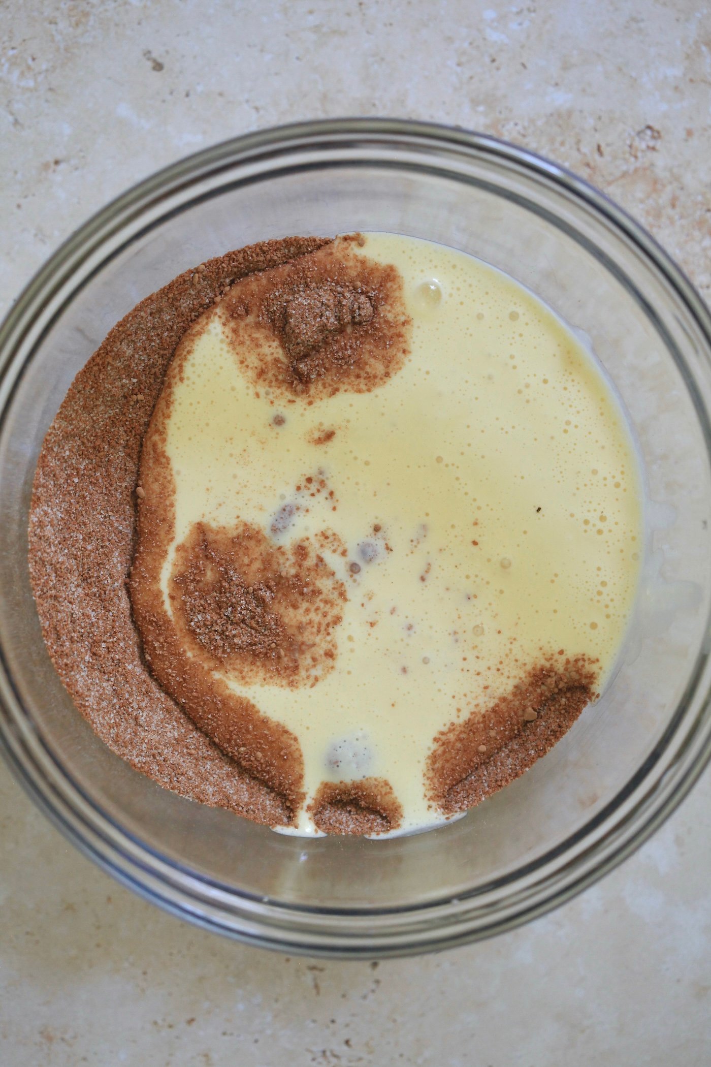 cocoa with yellow liquid in mixing bowl.