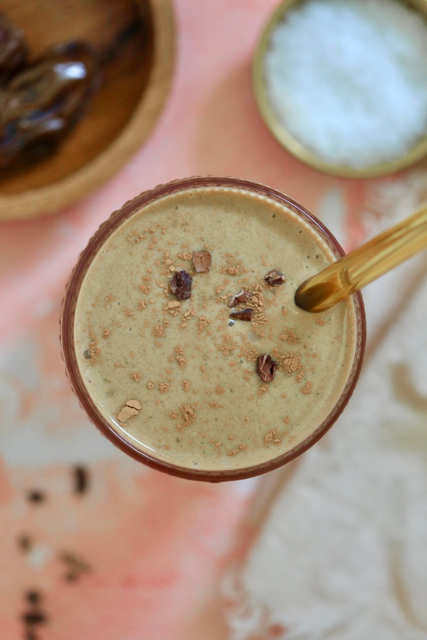 overhead view of smoothie with gold straw.