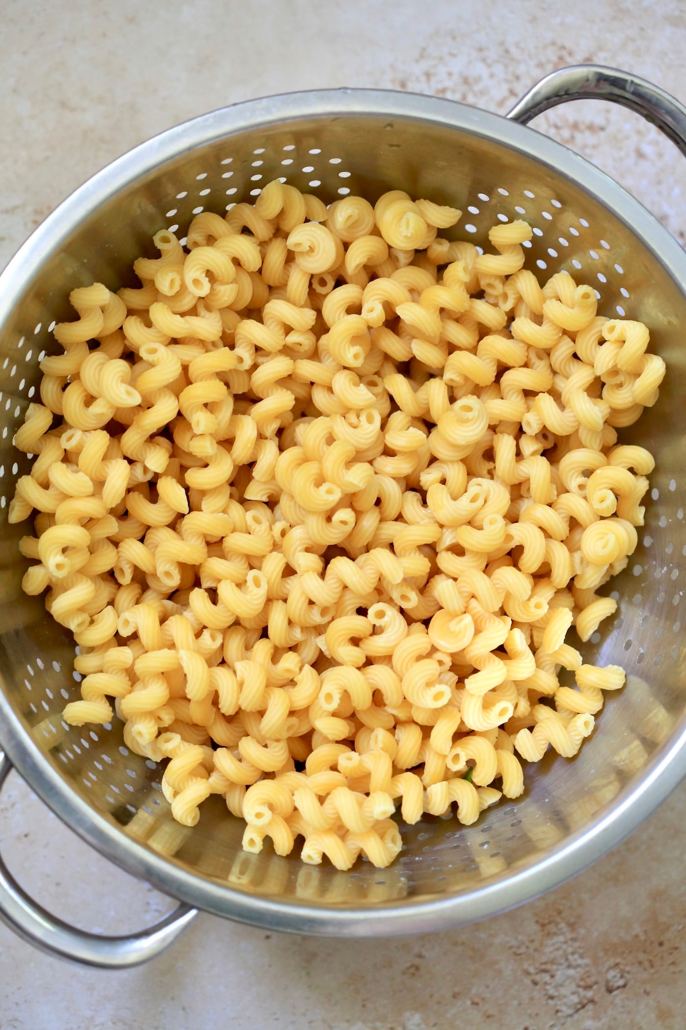 cooked pasta in strainer.