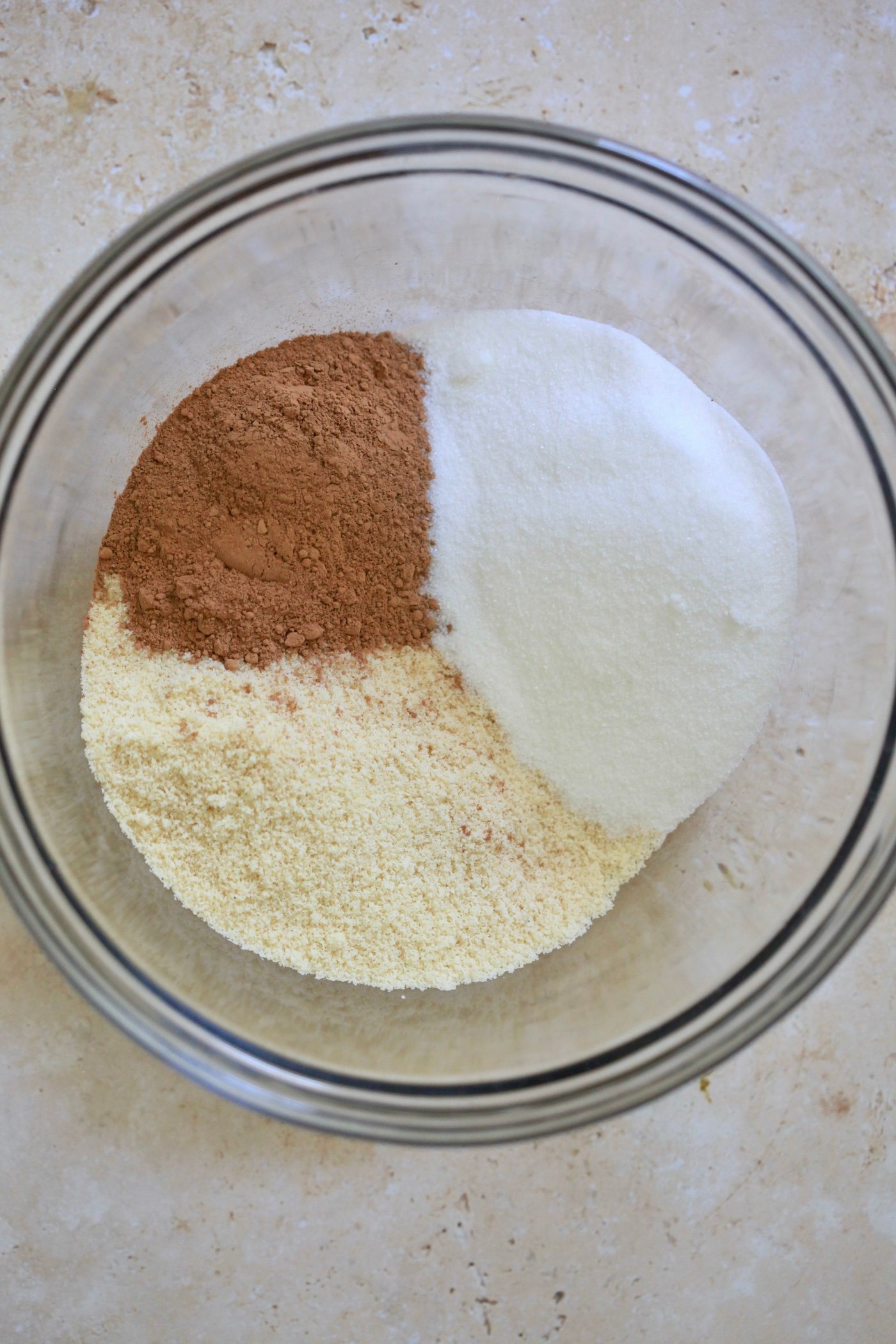 sugar, cocoa and almond flour in mixing bowl.