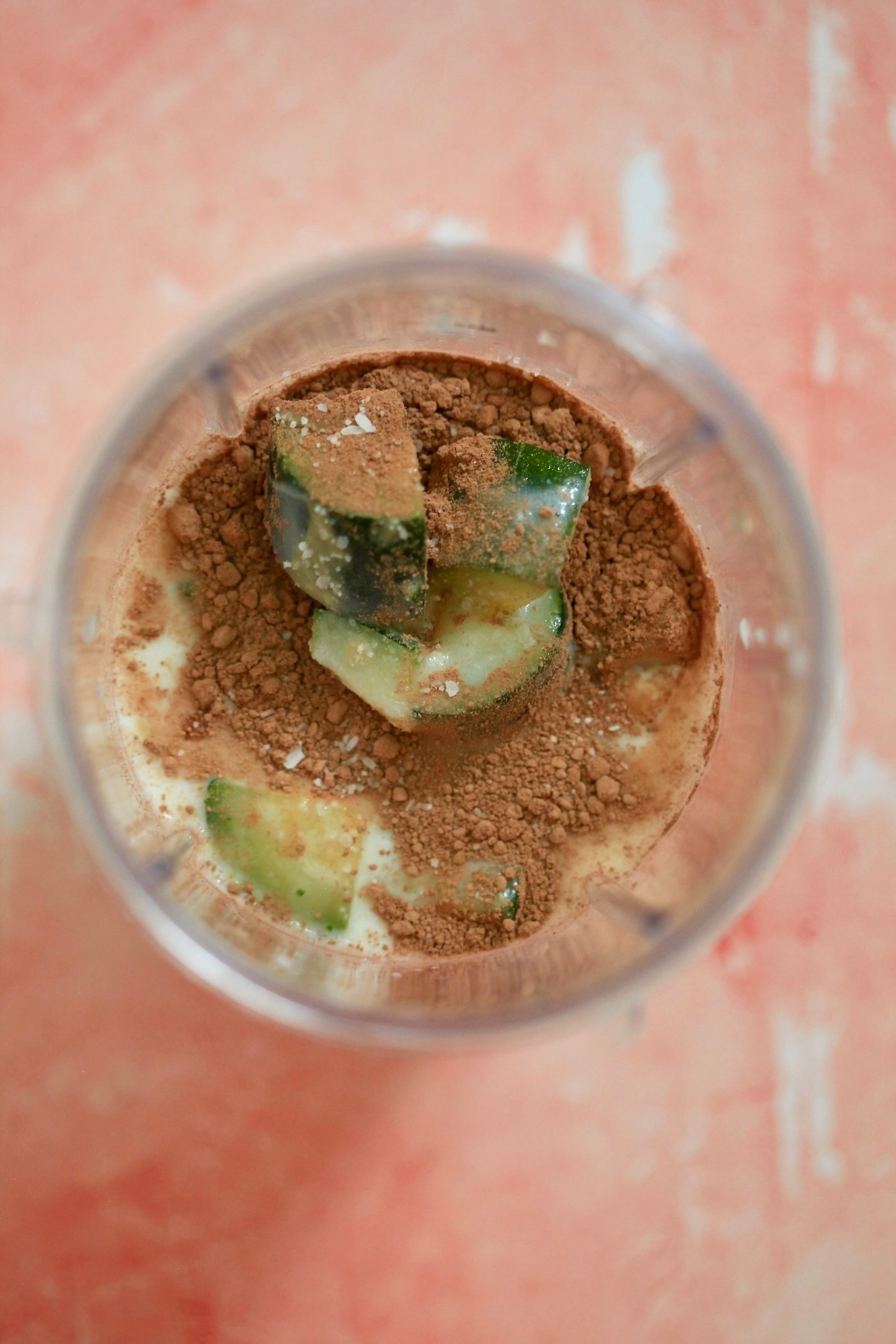 zucchini, cocoa, and milk in blender jar