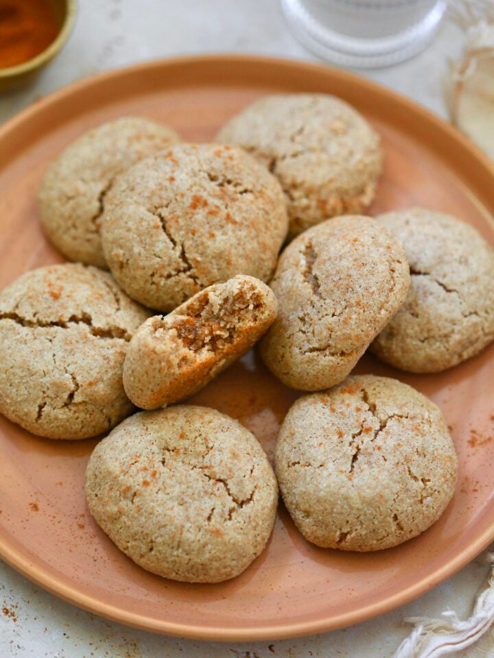 plate of cinnamon cookies with bite taken out.