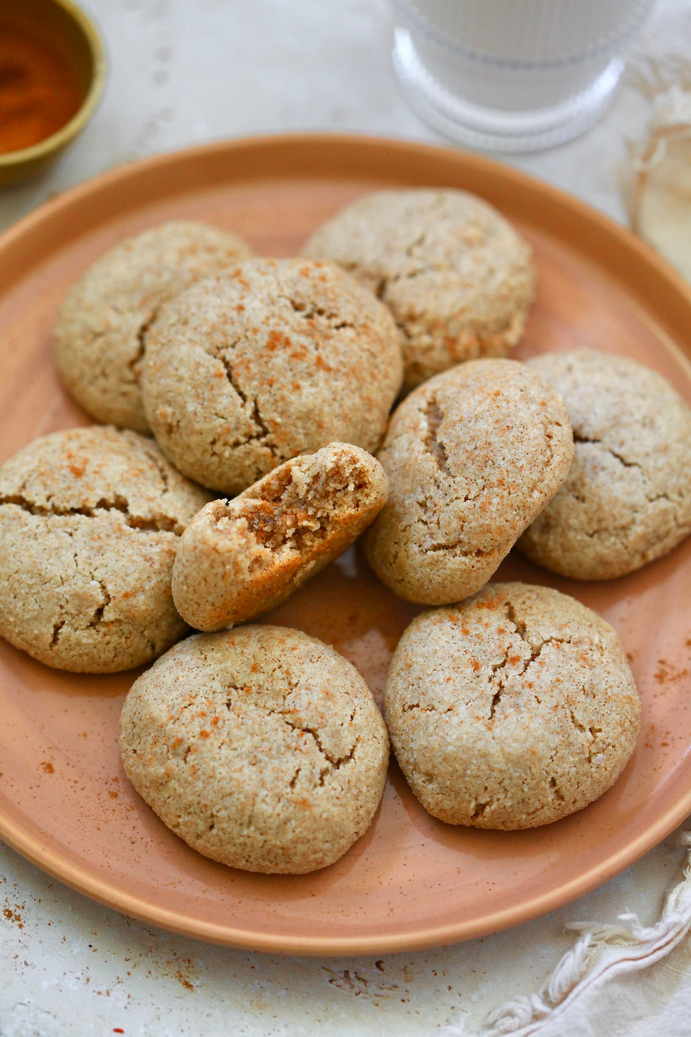 plate of cinnamon cookies with bite taken out.