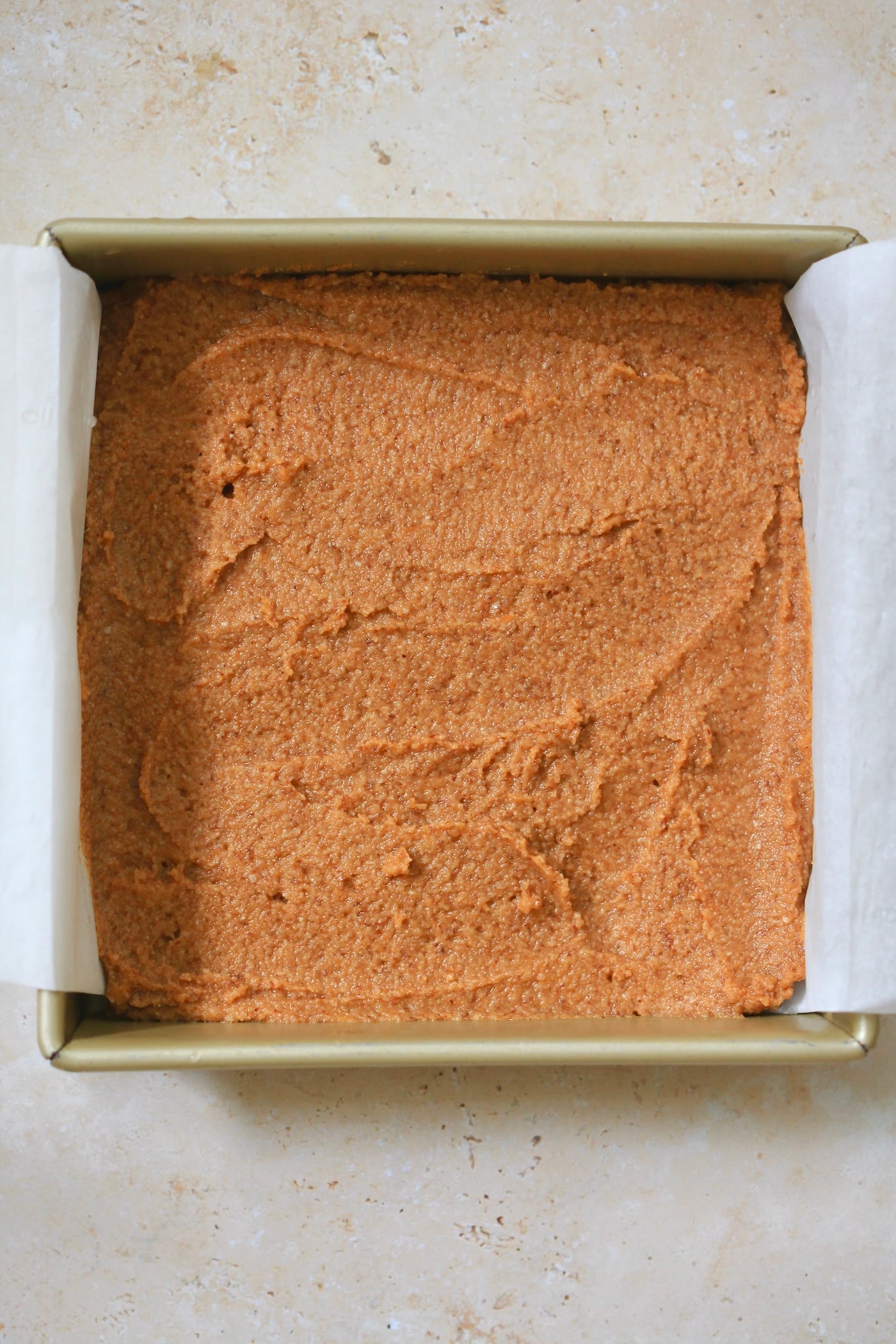 unbaked orange batter in pan