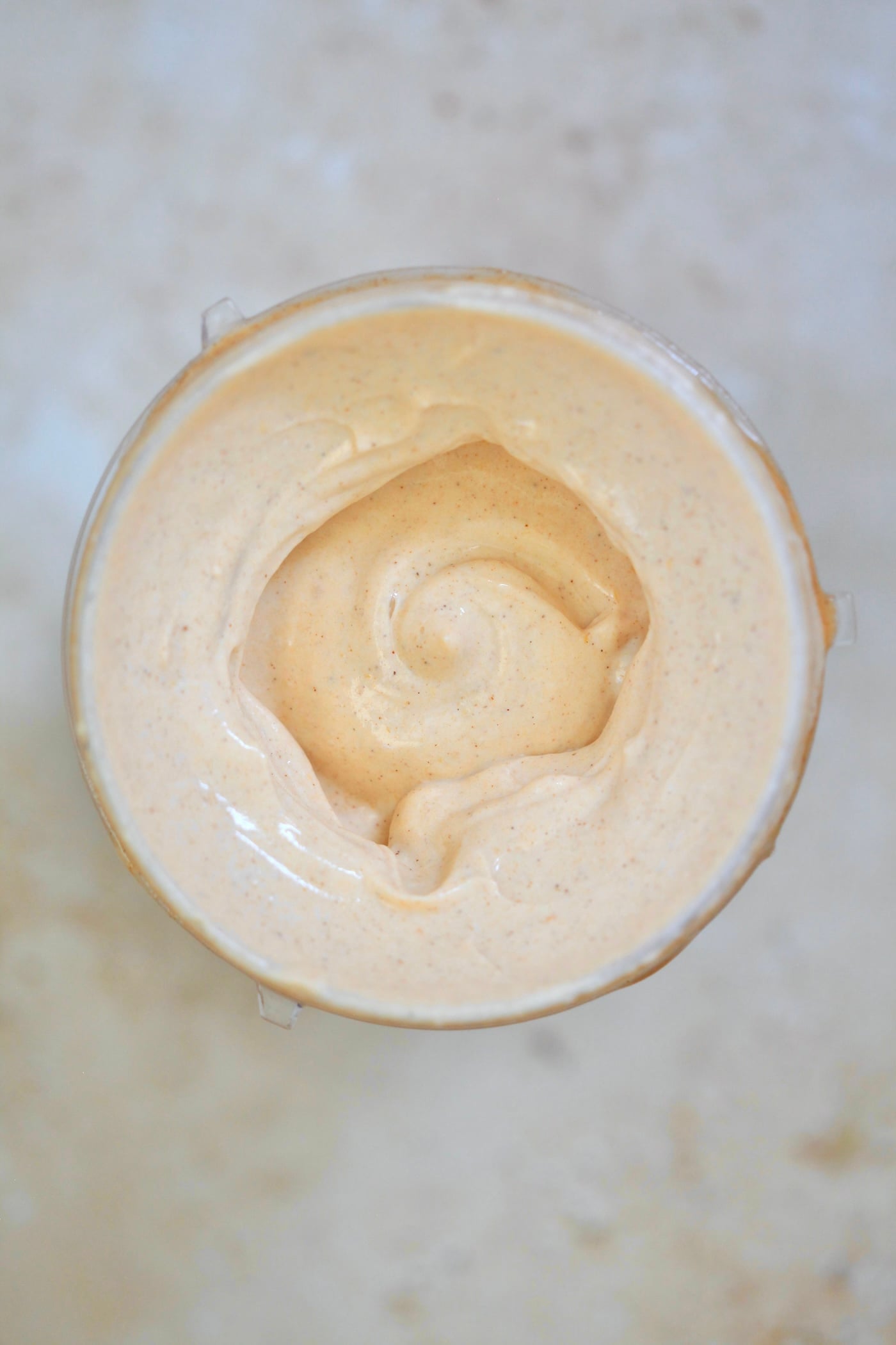 blended creamy light orange mixture in blender jar.