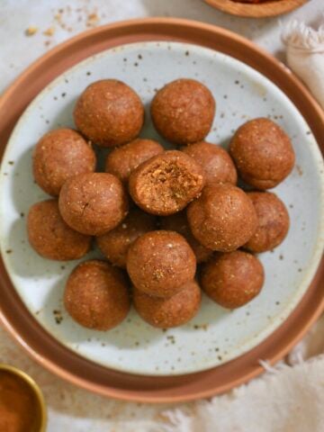 plate of orange balls with pumpkin in background