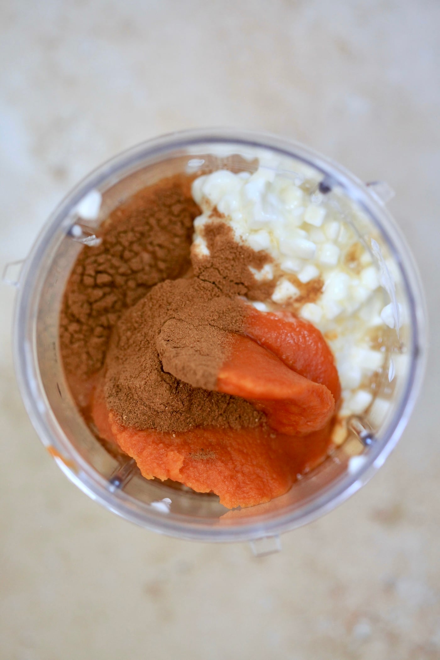 cottage cheese, pumpkin, and spices in blender jar.