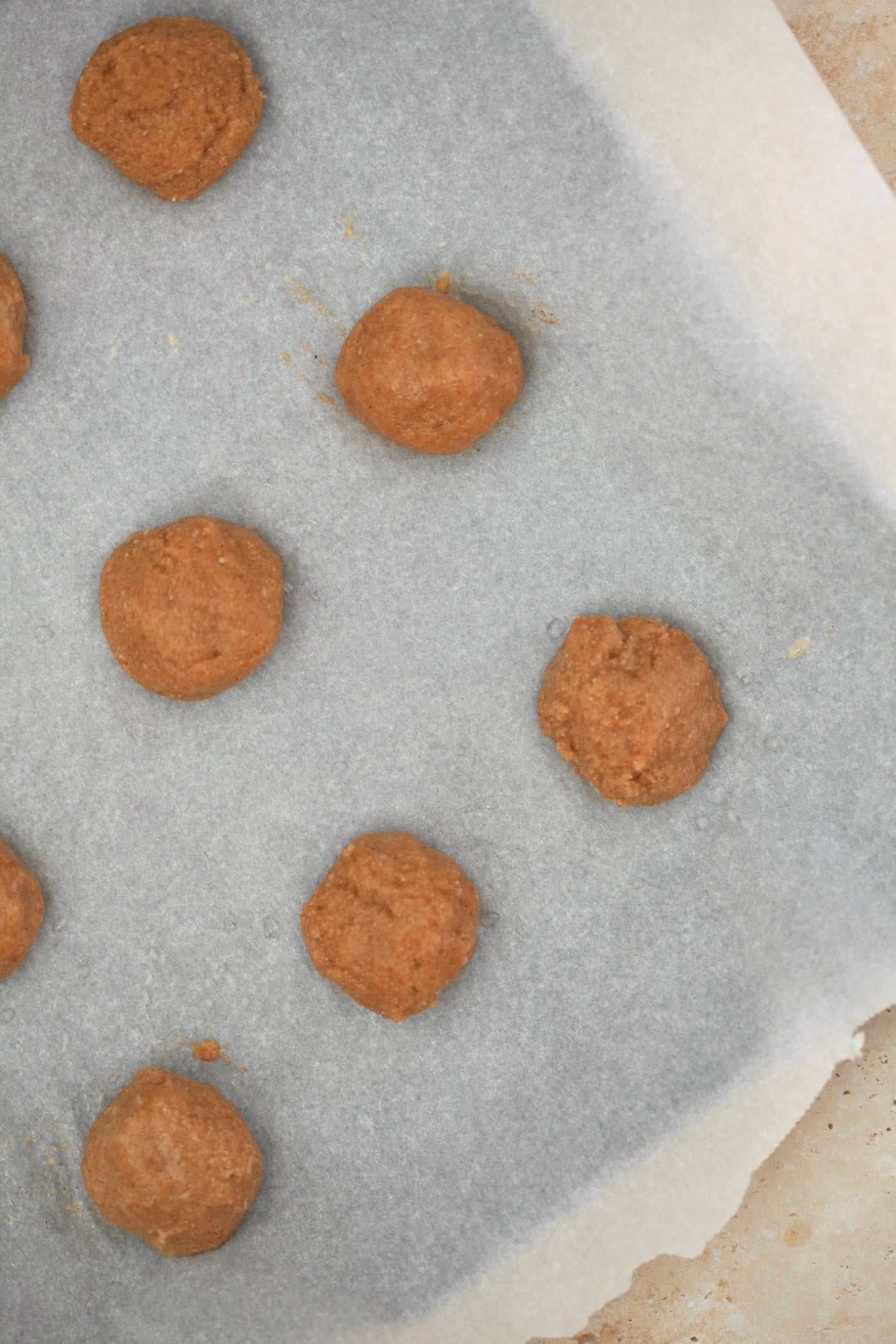 raw cookie dough balls on baking sheet.