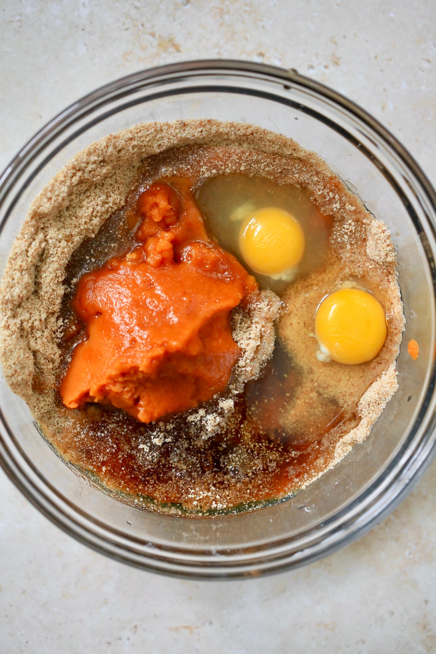 pumpkin and eggs in mixing bowl with flour.