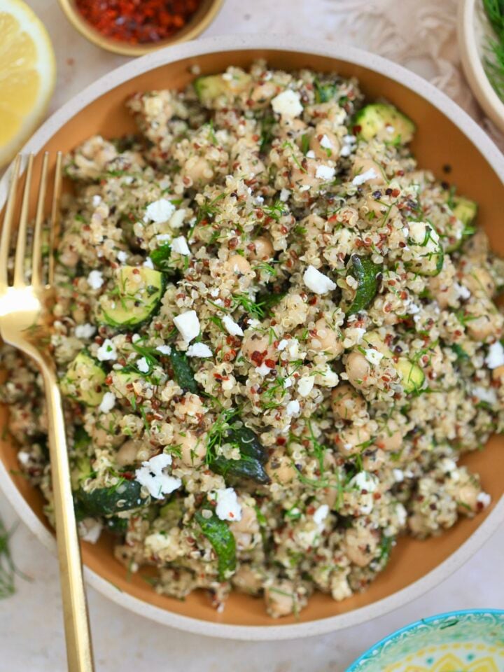 bowl of quinoa salad with gold fork.