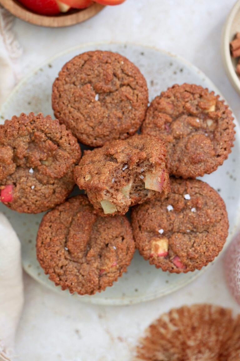 plate of brown muffins with bite taken out