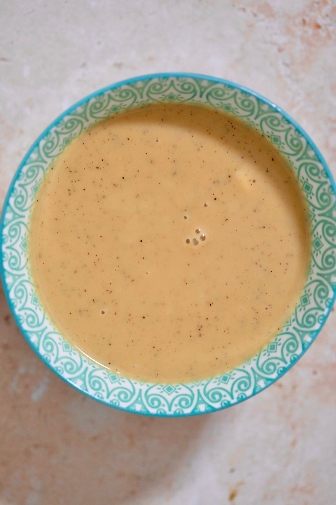 brown dressing in blue bowl.