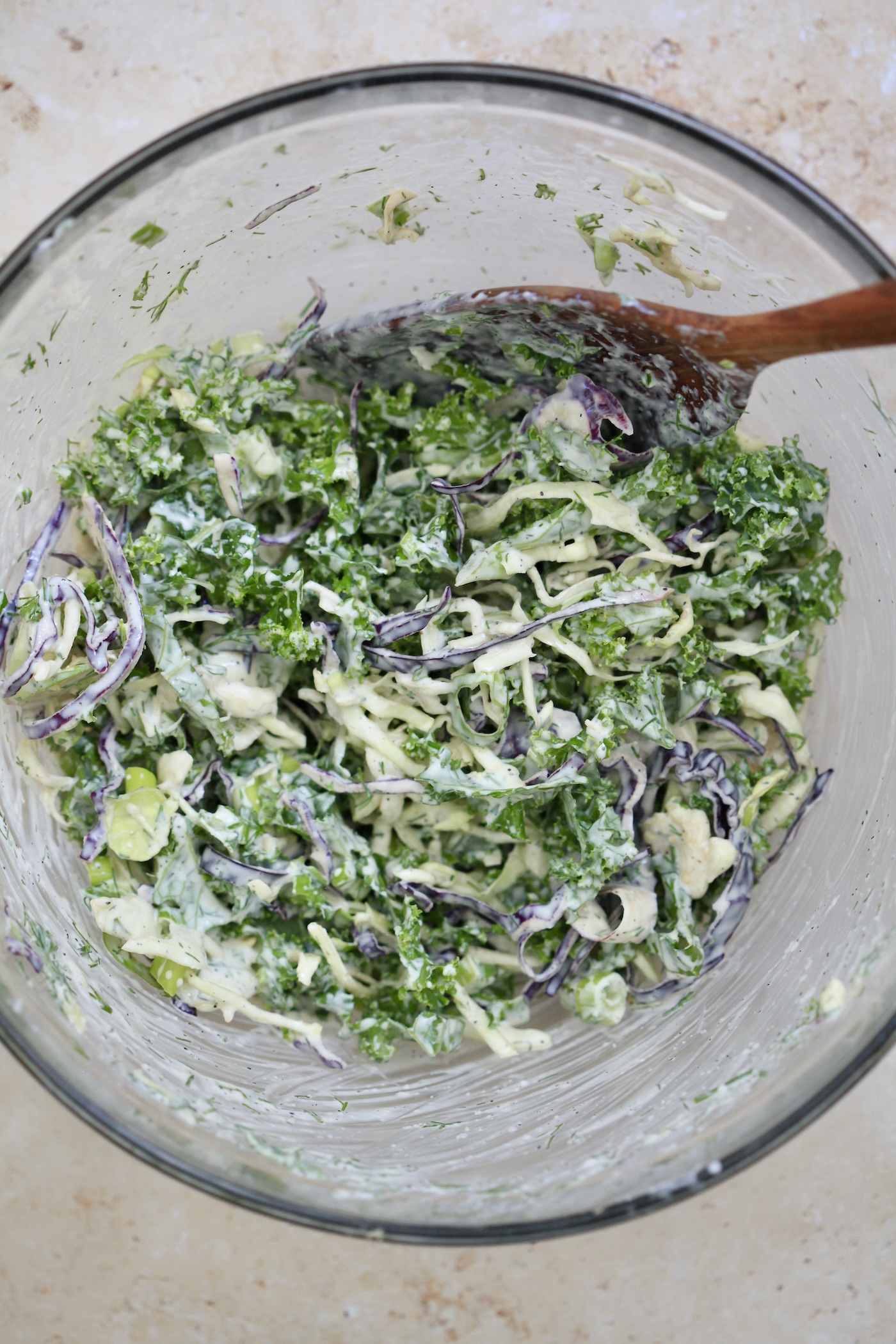 green slaw in creamy dressing in bowl.