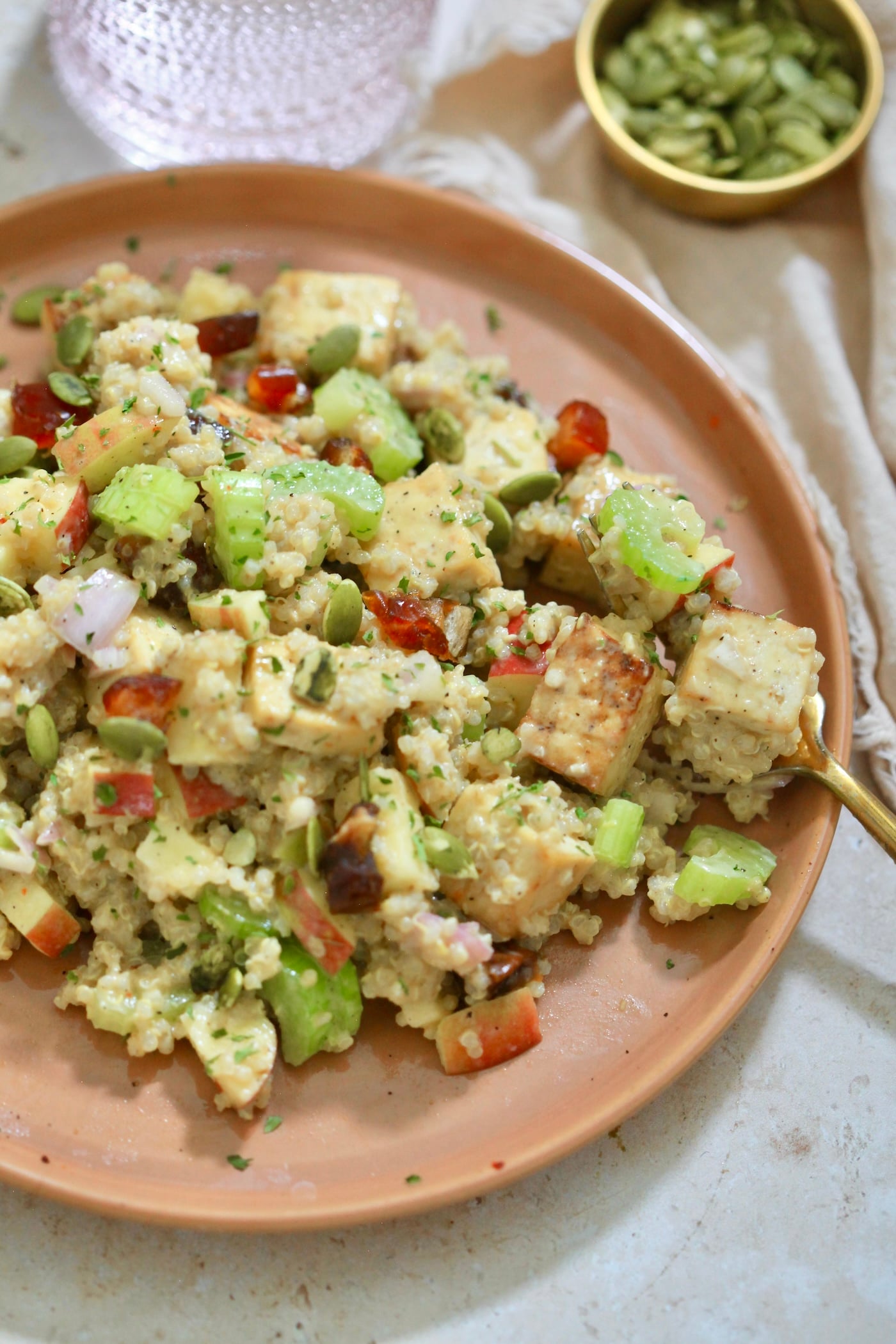 side view of quinoa salad on brown plate.