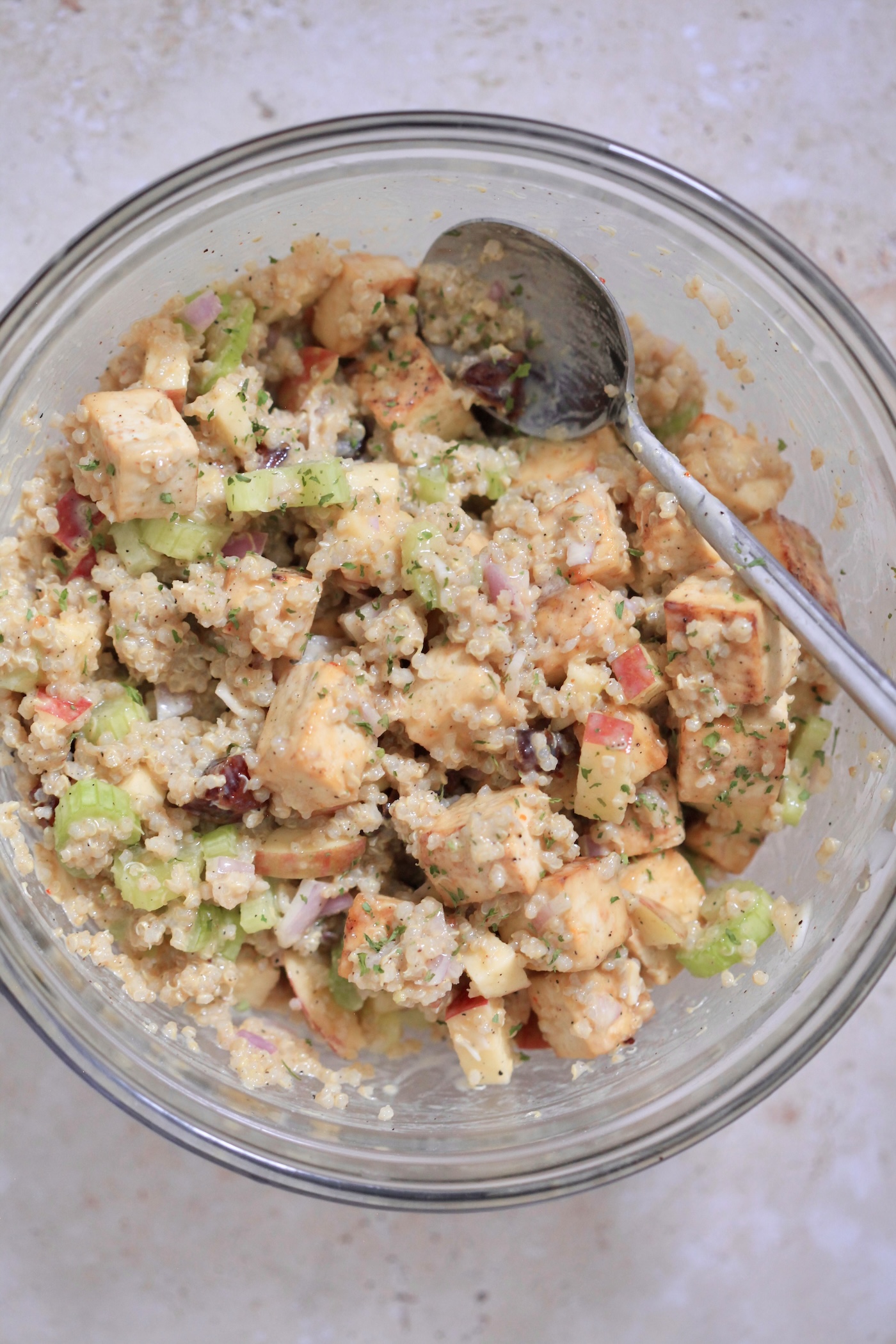 mixed quinoa salad with spoon.