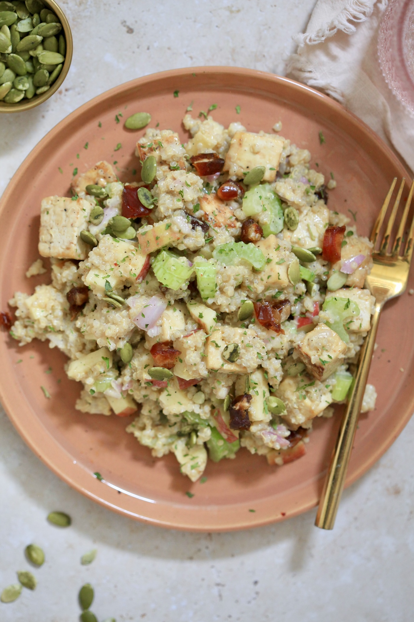 brown plate with tofu and quinoa mixture.
