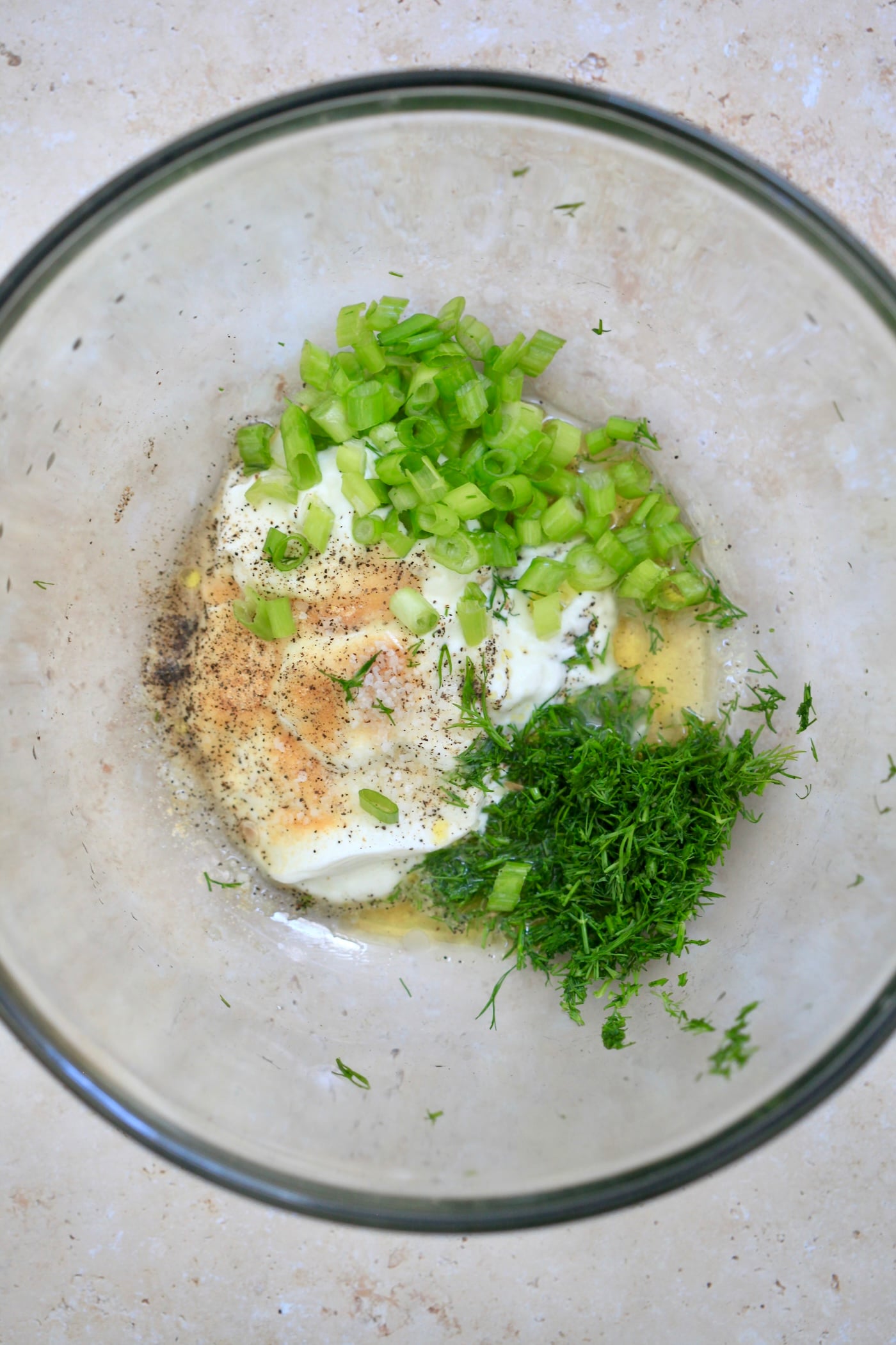yogurt, herbs and spices in mixing bowl