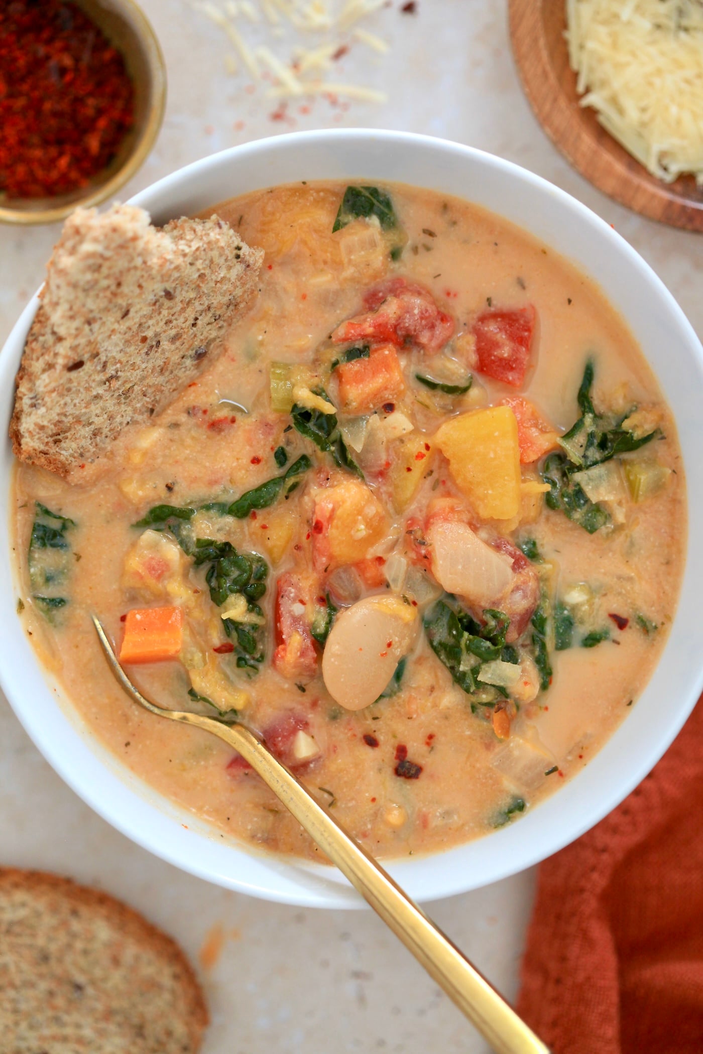 bowl of creamy soup with beans, greens, and squash