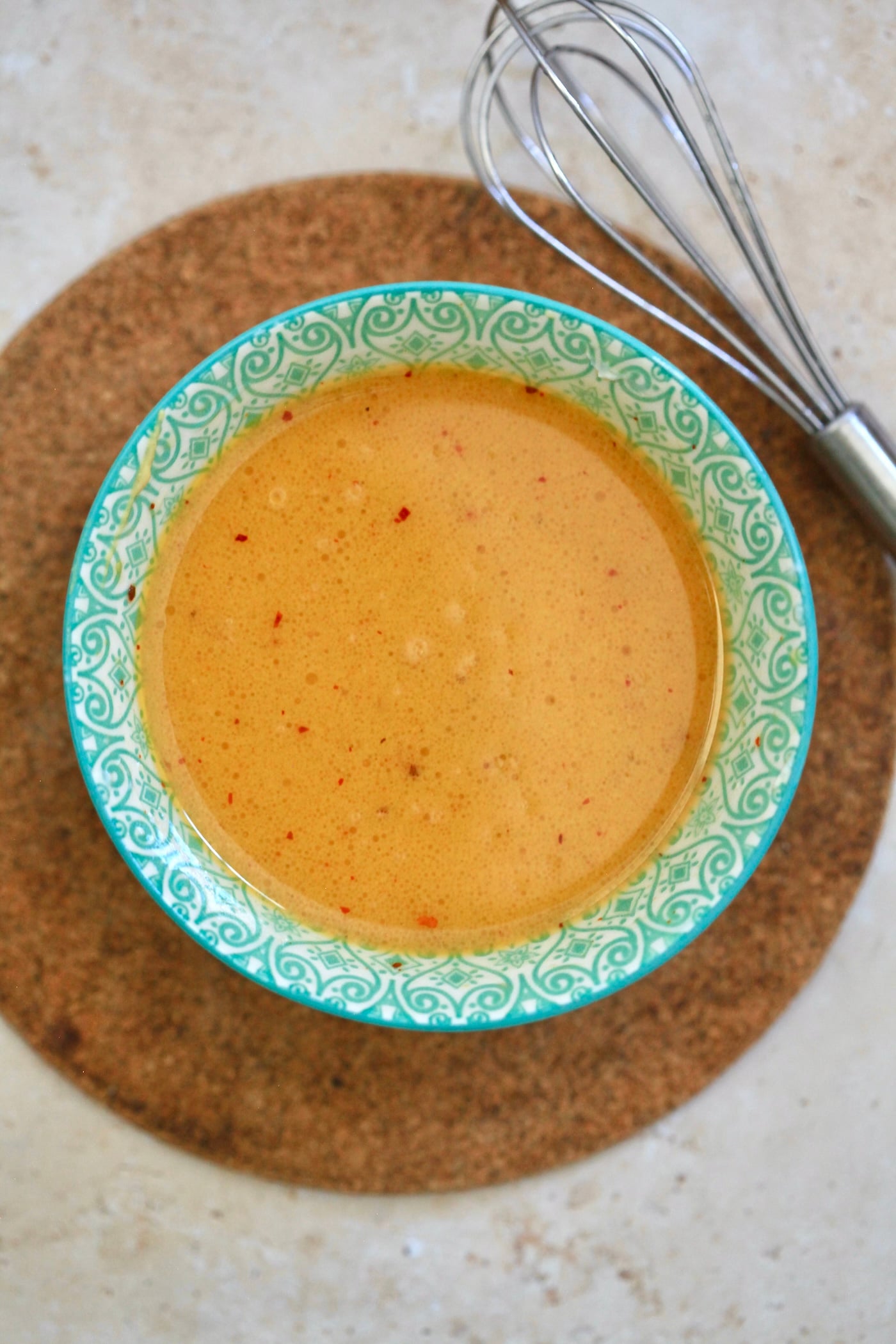 yellow dressing in blue bowl