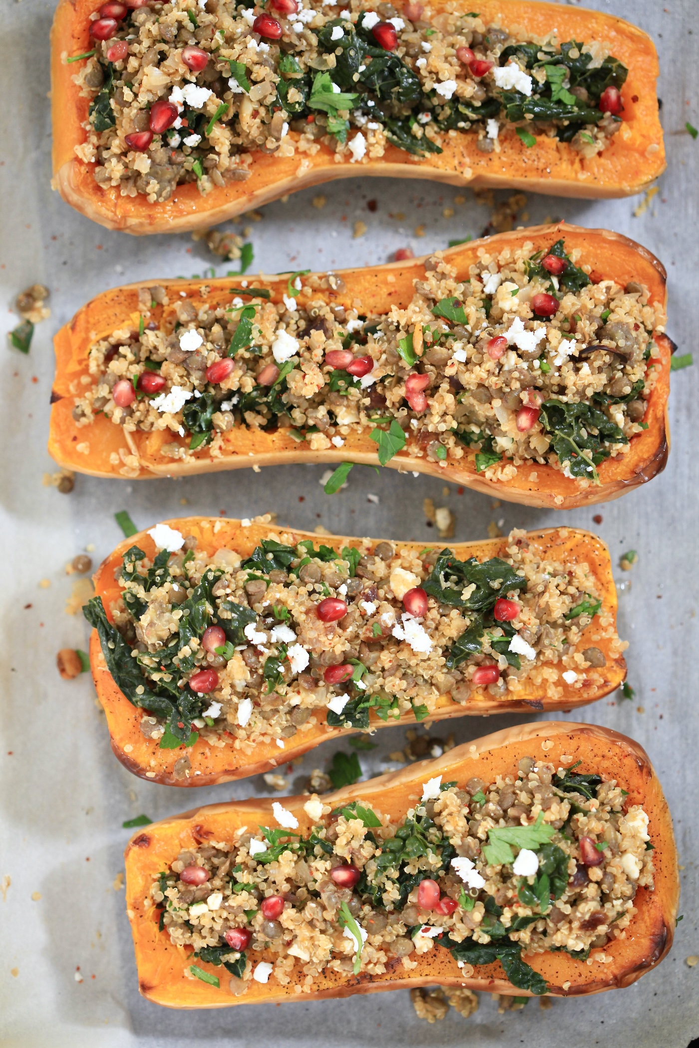 stuffed squash halved on baking sheet.