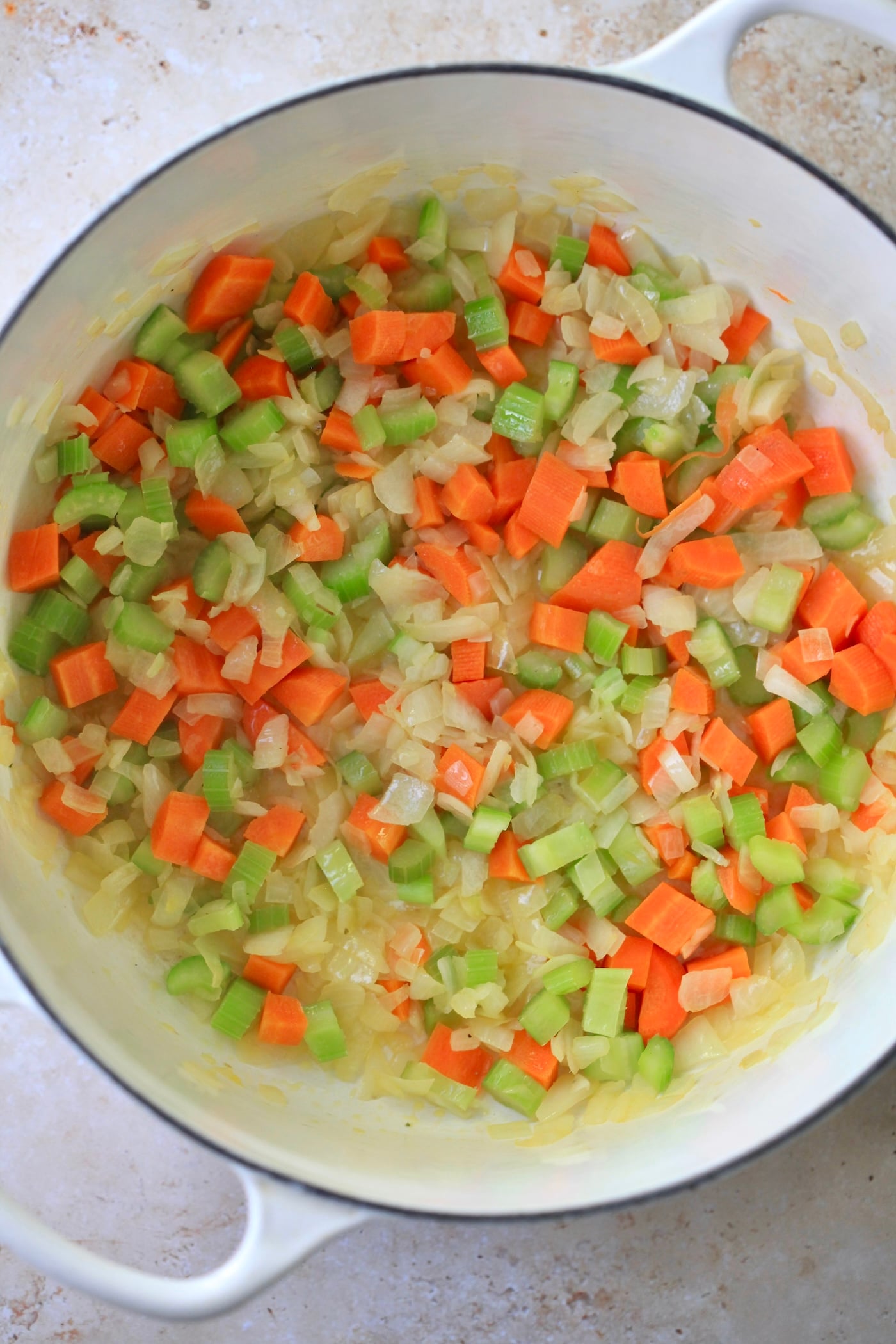 mirepoix cooking in white pot.