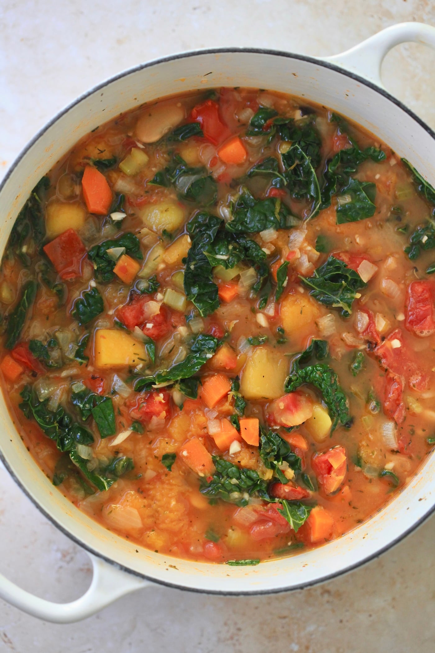 kale, beans, broth and tomatoes in soup pot