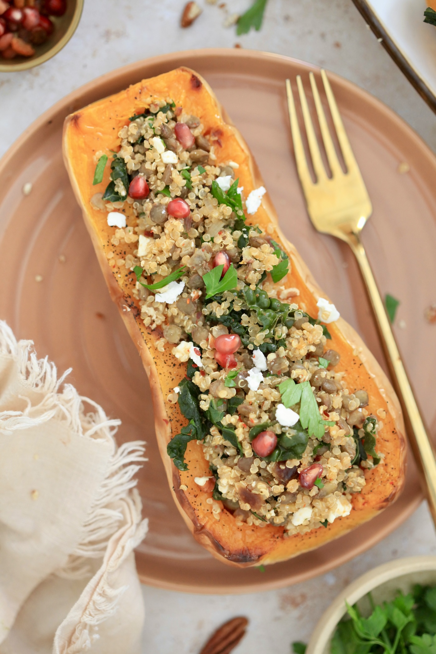 one stuffed squash half on plate with gold fork
