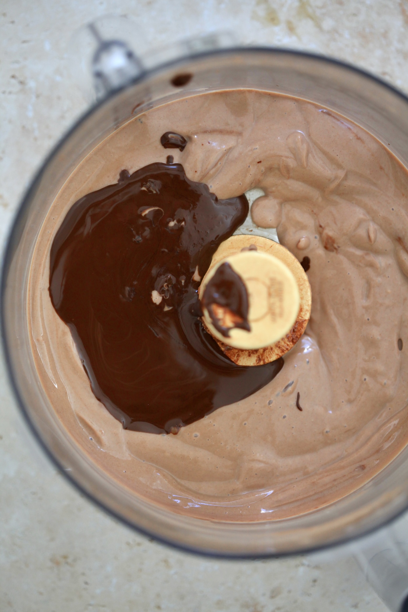 melted chocolate on chocolate pudding in food processor.