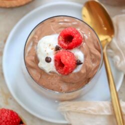 overhead view of chocolate pudding with gold spoon.