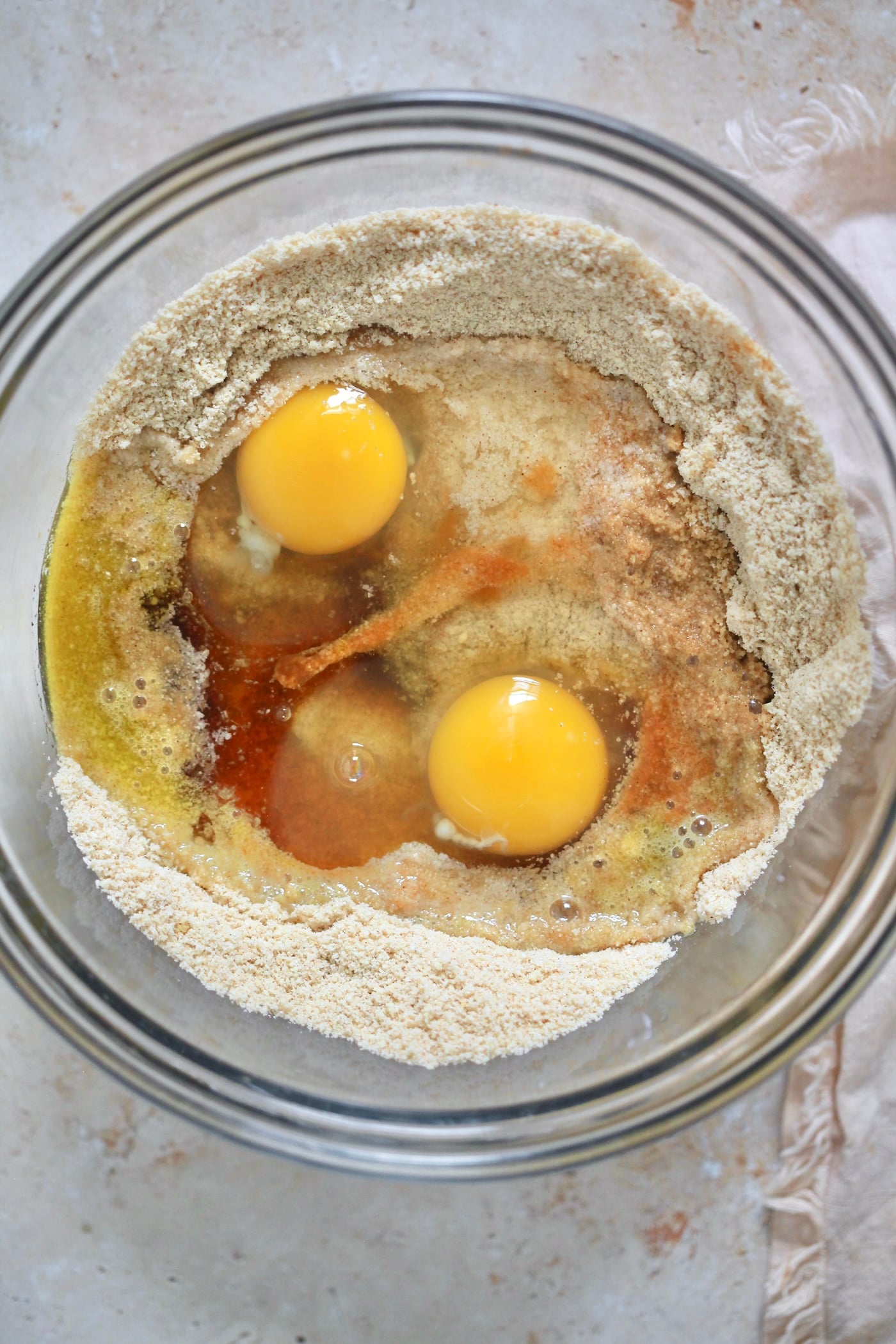 eggs and vanilla over flour in mixing bowl.